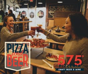 girls toasting beer and wine with pizza on the table